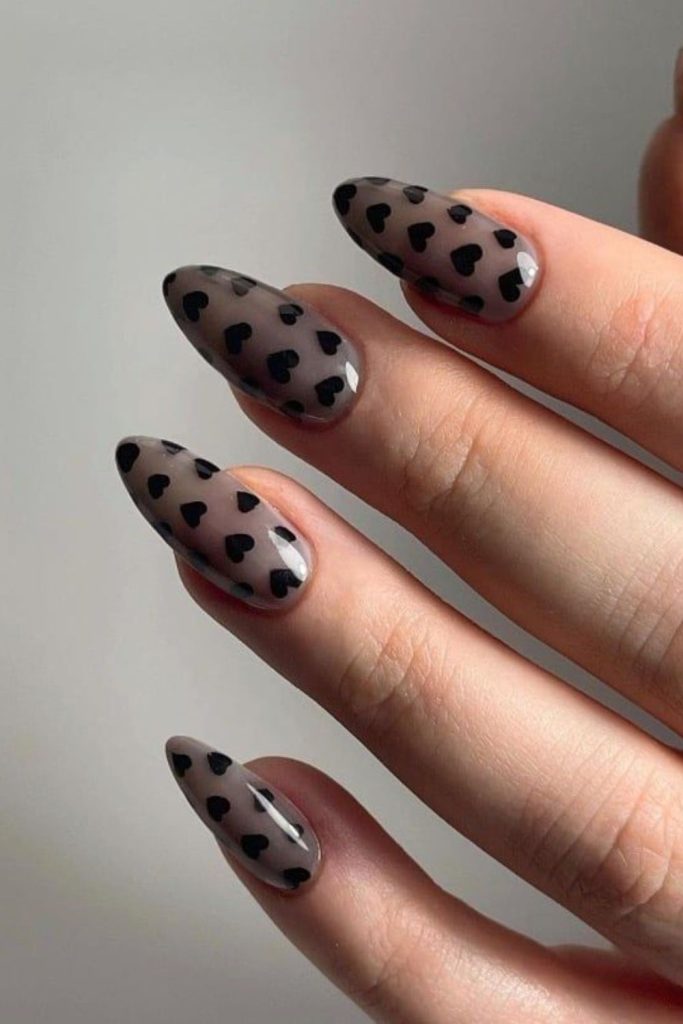 Translucent black nails with black hearts