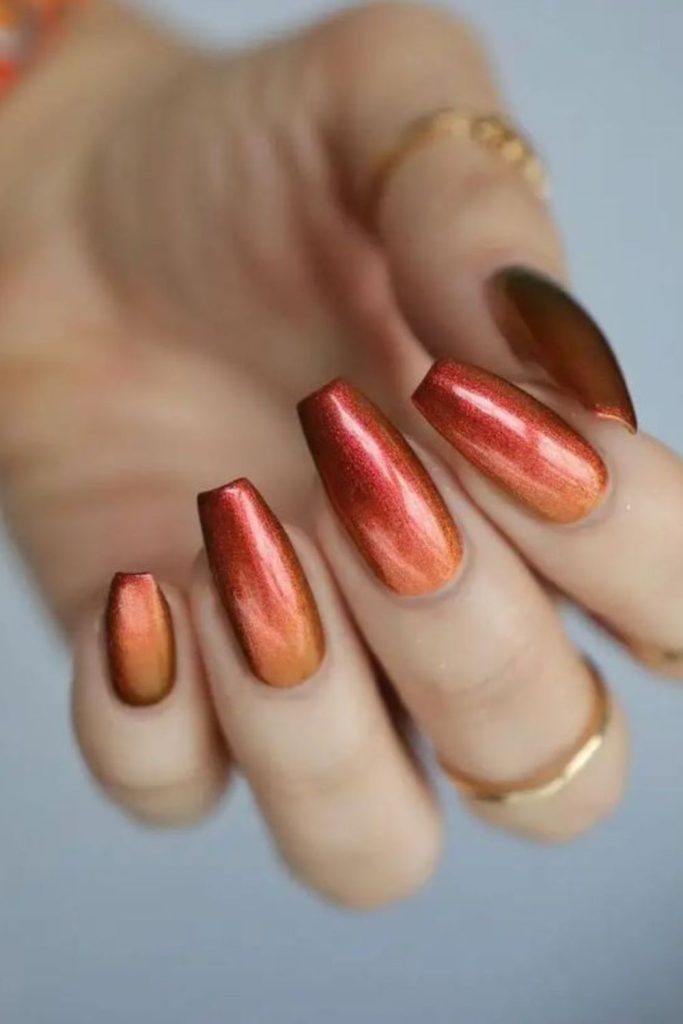Earthy desert nails with golden shimmer.