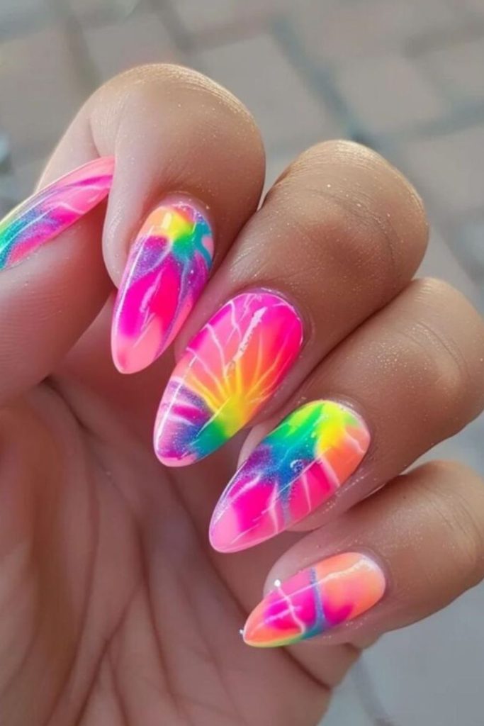 Neon tie-dye nails with chaotic swirls.