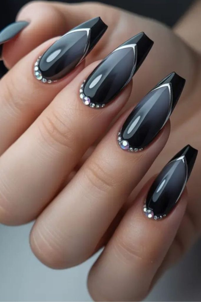 Coffin-shaped black nails with silver charms