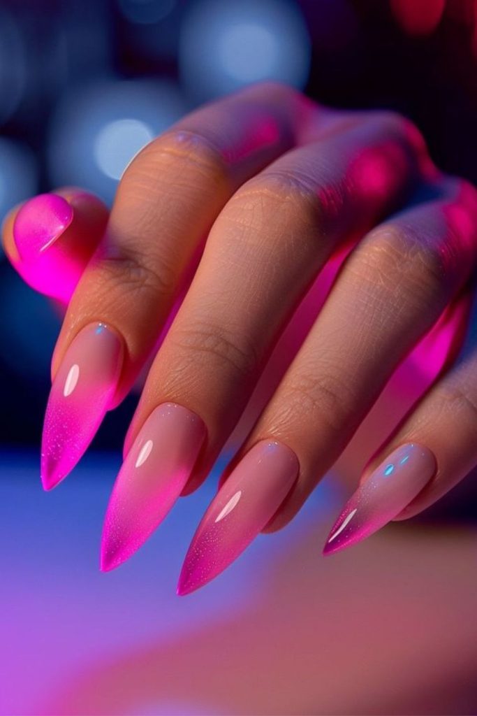 Neon pink nails with playful sparkle.