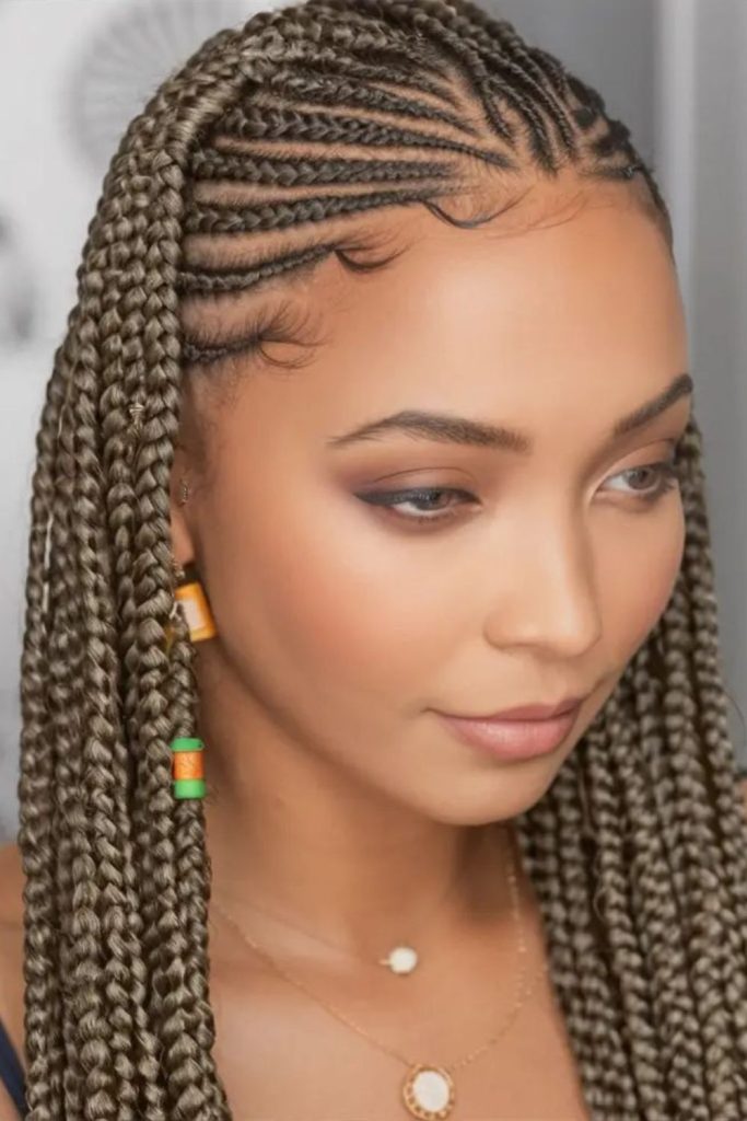 Green-accented braids with metallic charms