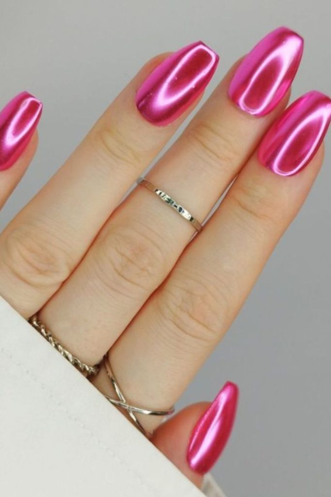 Bold fuchsia nails with holo accents.