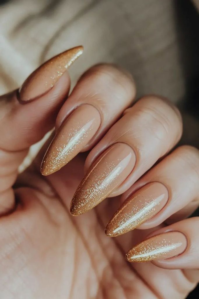 Golden nails with soft shimmer haze.