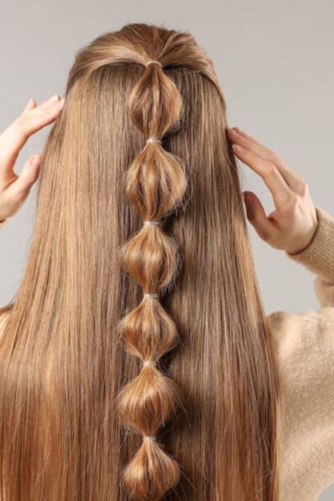 Half-up bubble braid with whimsical bounce