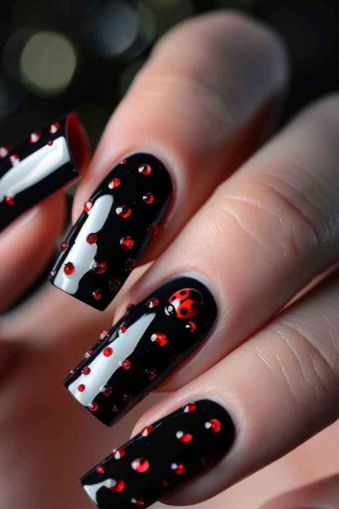 Black nails with crimson diamond motifs