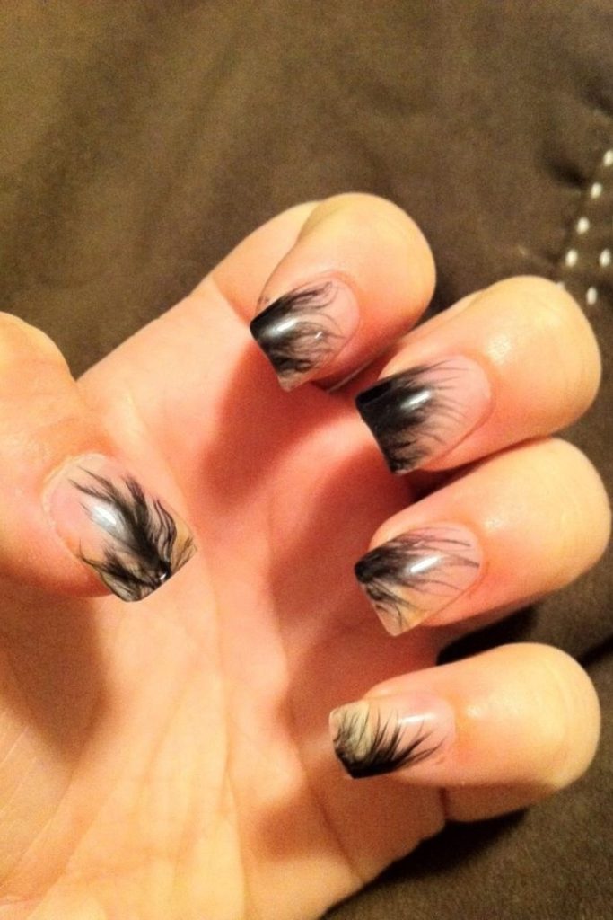 Feather-pattern nails with opalescent shimmer.