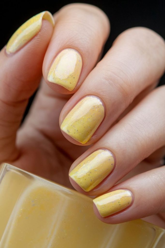 Yellow nails with shimmering accents