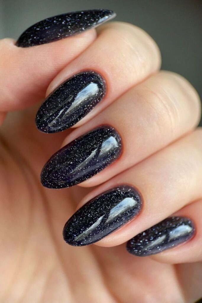 Dark nails with silver lunar fragments.