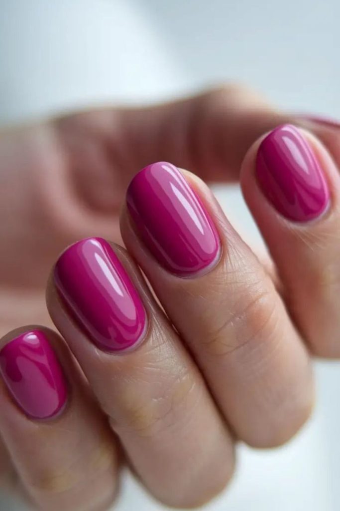 Magenta nails, bold playful energy.