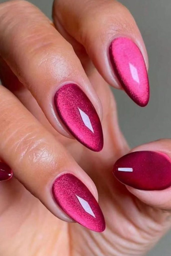 Fluorescent pink nails with holographic shimmer.