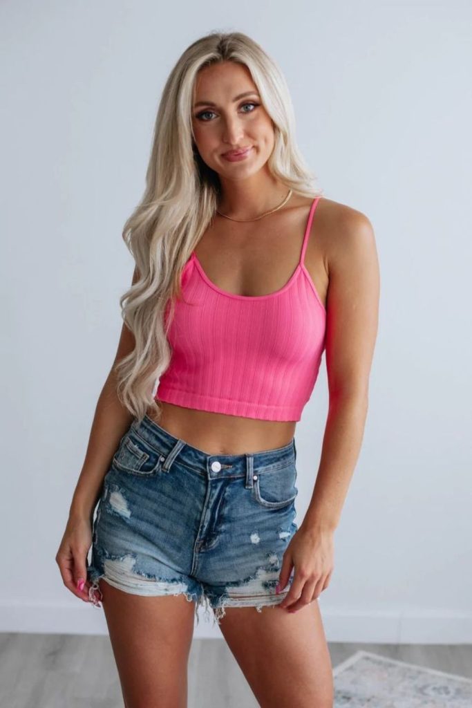 Neon tank denim cutoffs playful look.