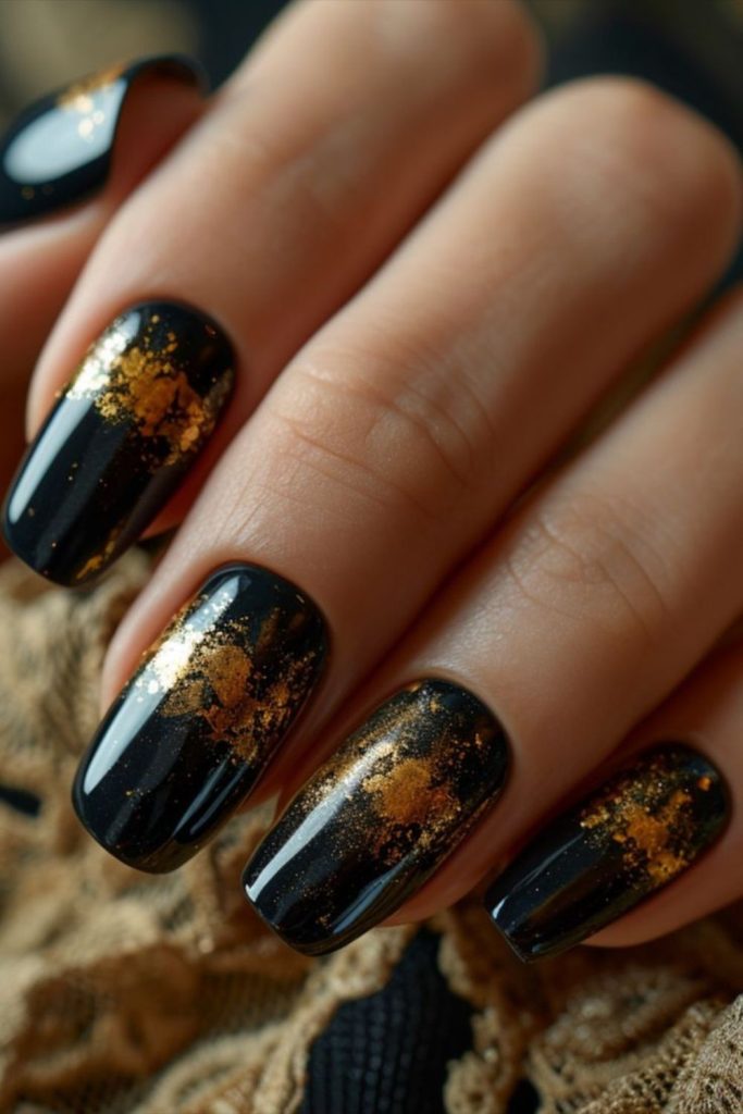 Black nails with fiery glitter streaks.