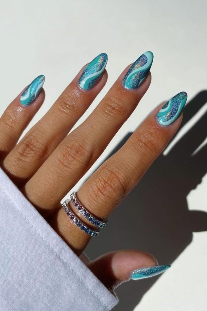 Teal nails with wave-like gradients.