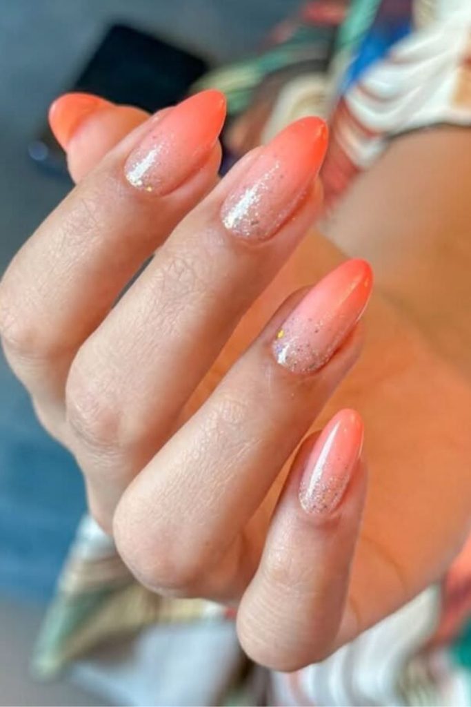 Peach nails with tiny golden flecks