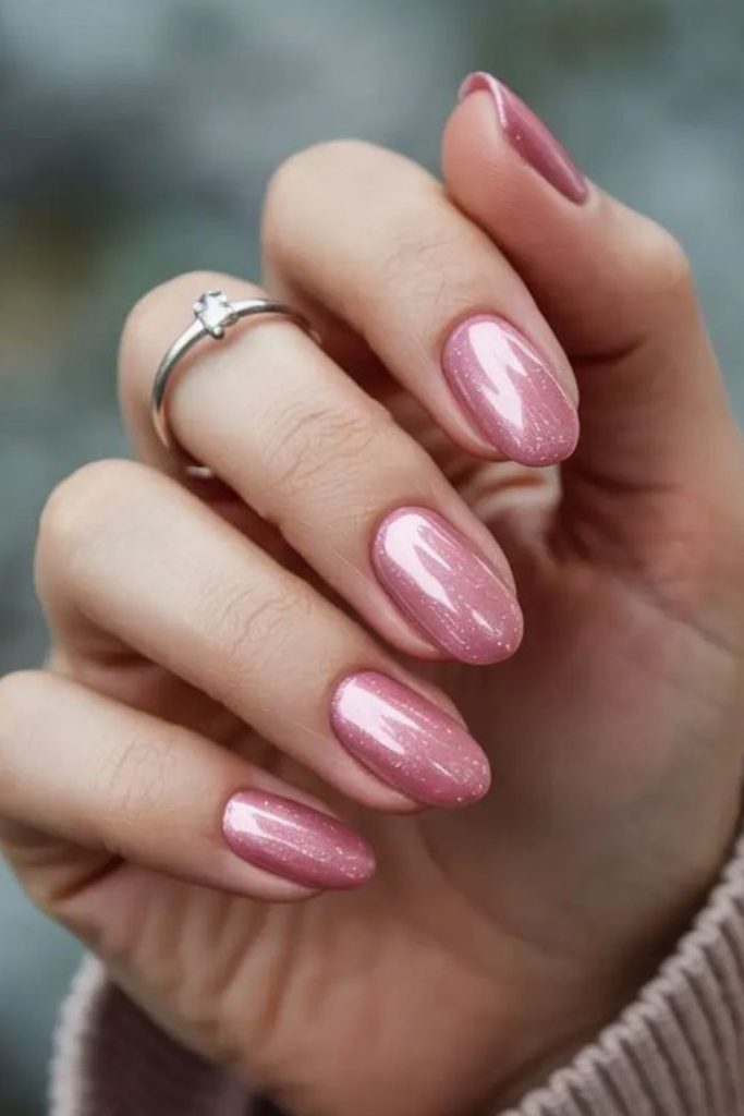 Blush pink nails with reflective shards.