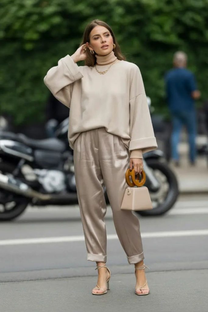 Neutral sweater satin trousers chic outfit.