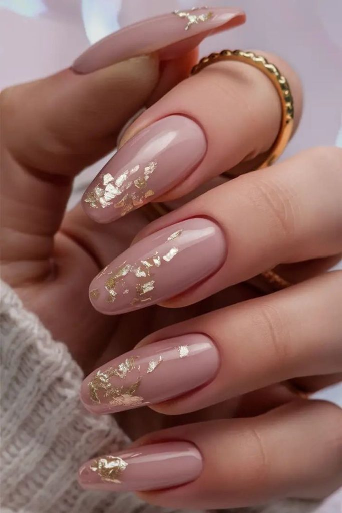 Dusky rose nails with gold accents.