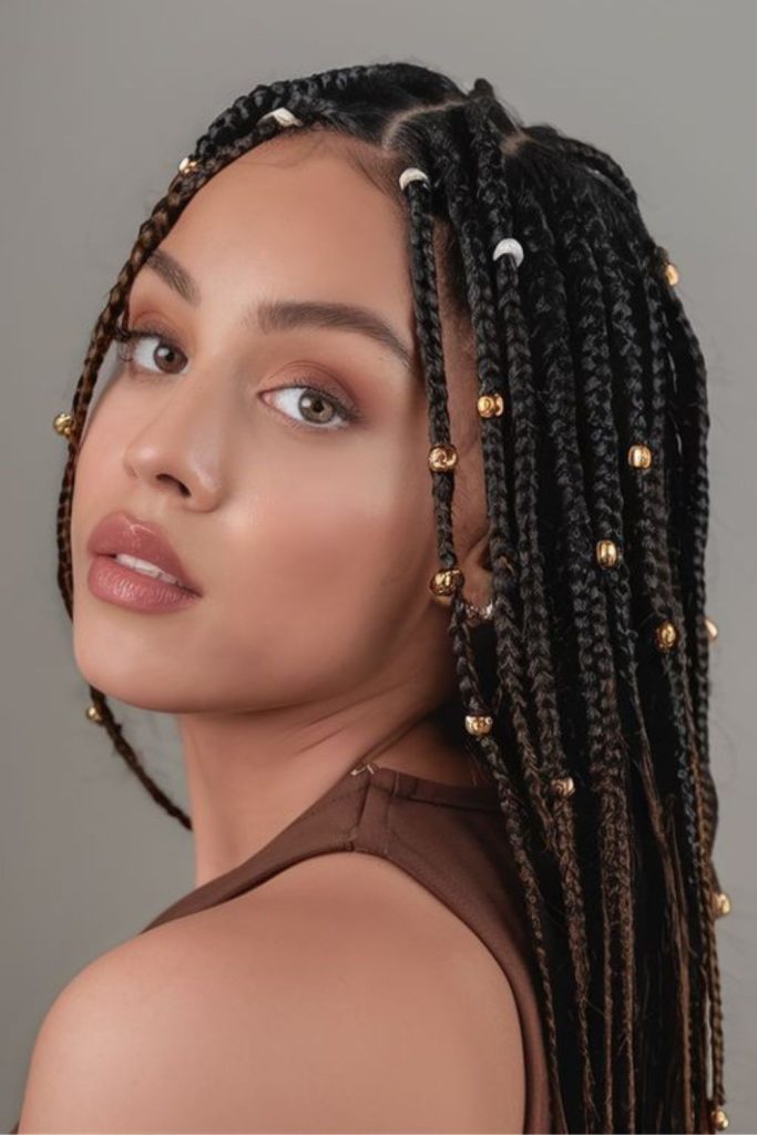Golden-beaded braids with loose wisps