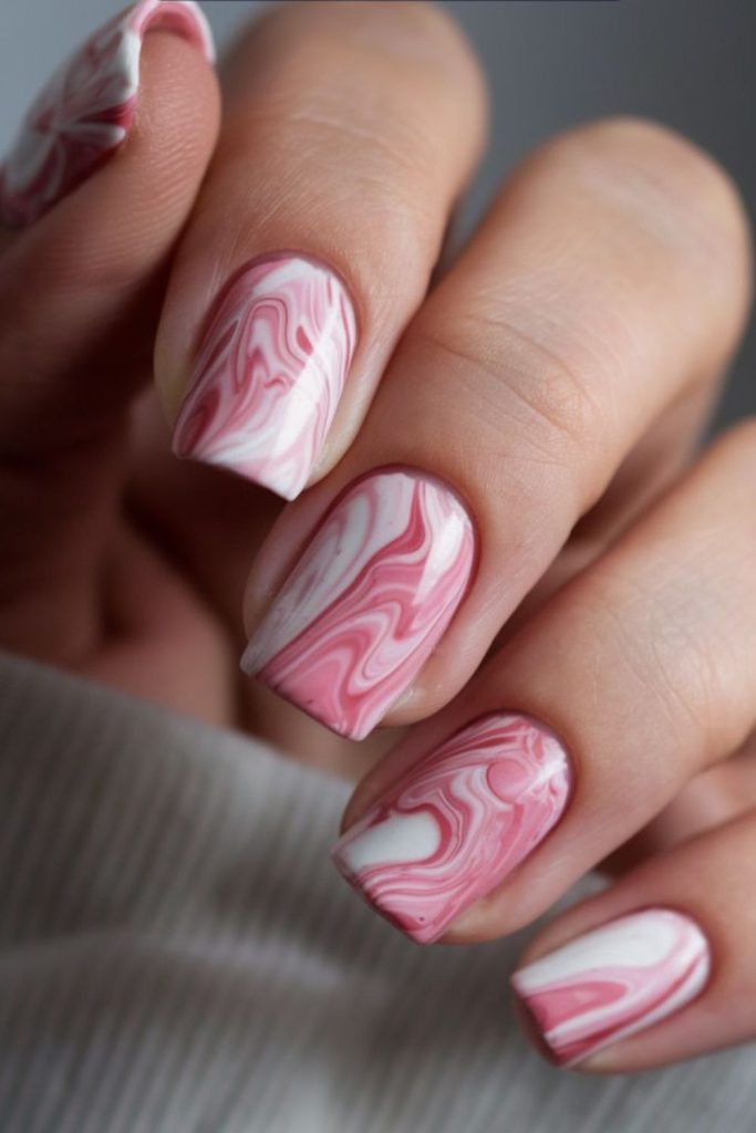 Gentle marble swirls over nude nails
