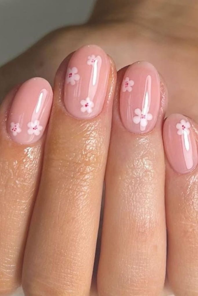 Small floral designs on pastel nails