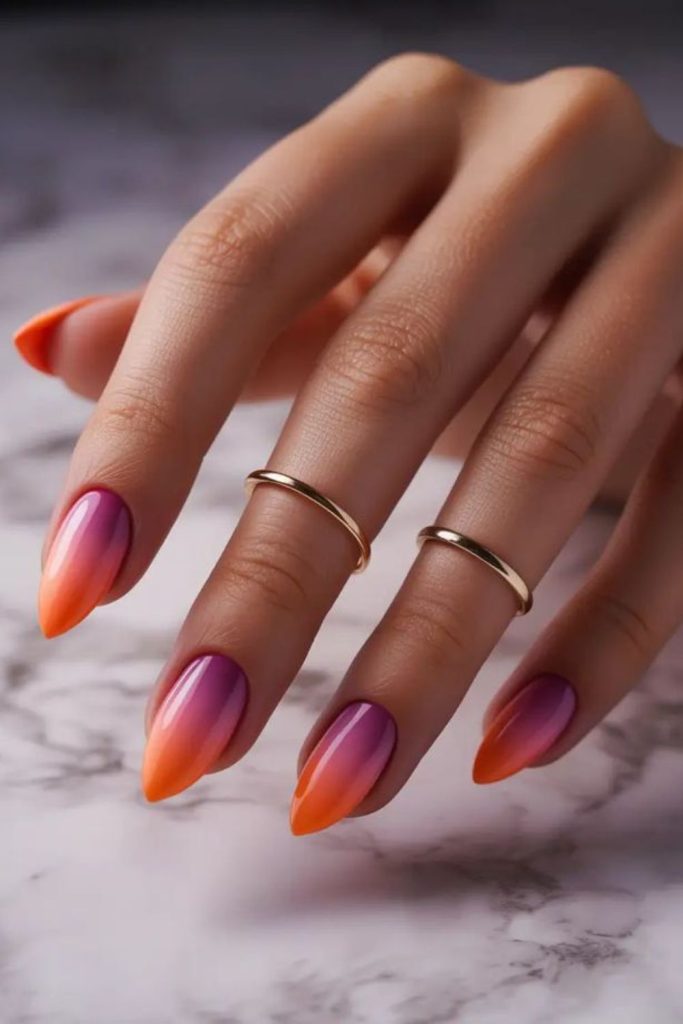 Sunset gradient nails with warm tones.