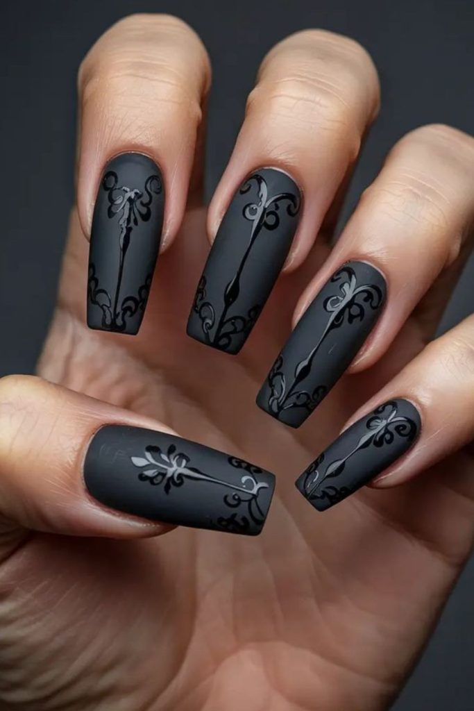 Grey nails etched with miniature gargoyles