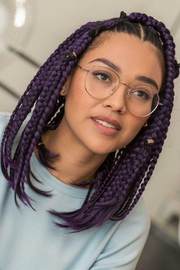 Purple ribboned braids flowing gracefully