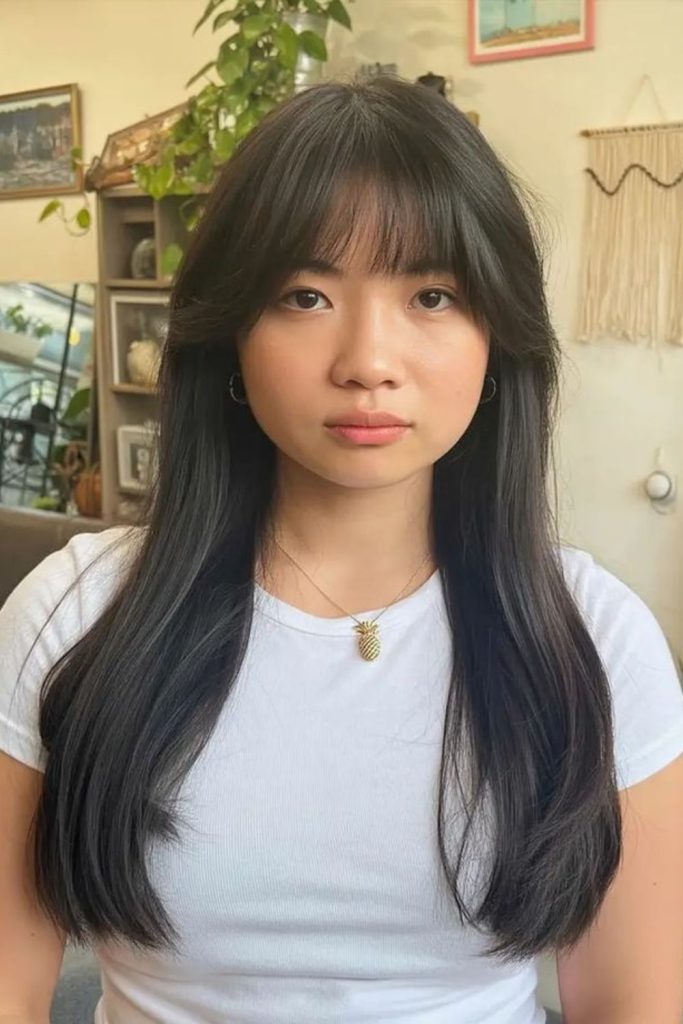 Soft curtain bangs flutter around face