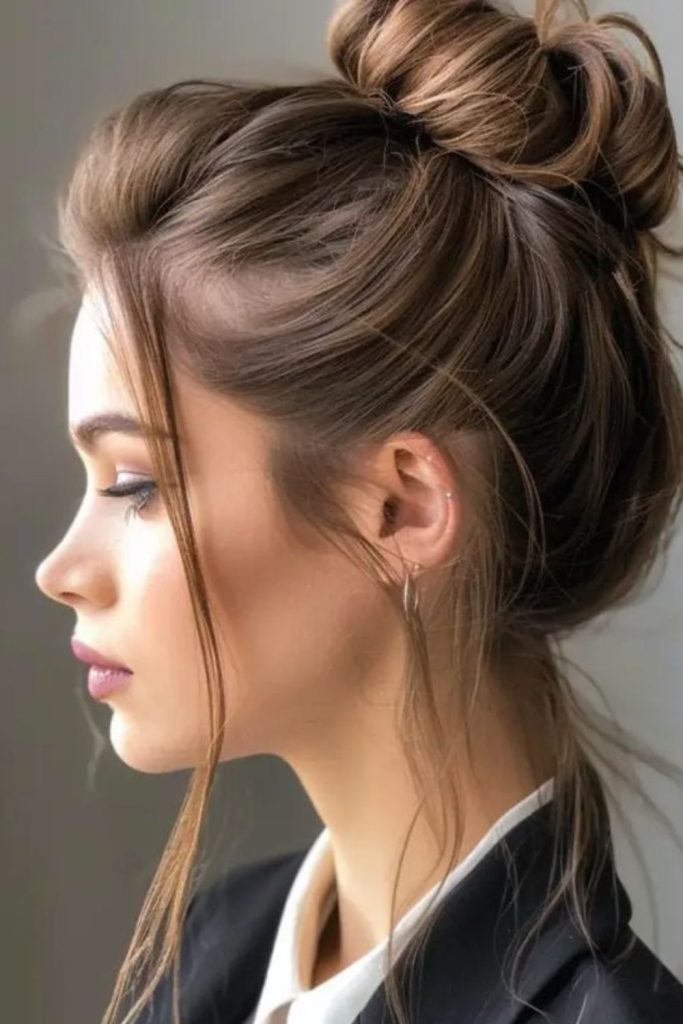 Messy bun with soft airy texture.