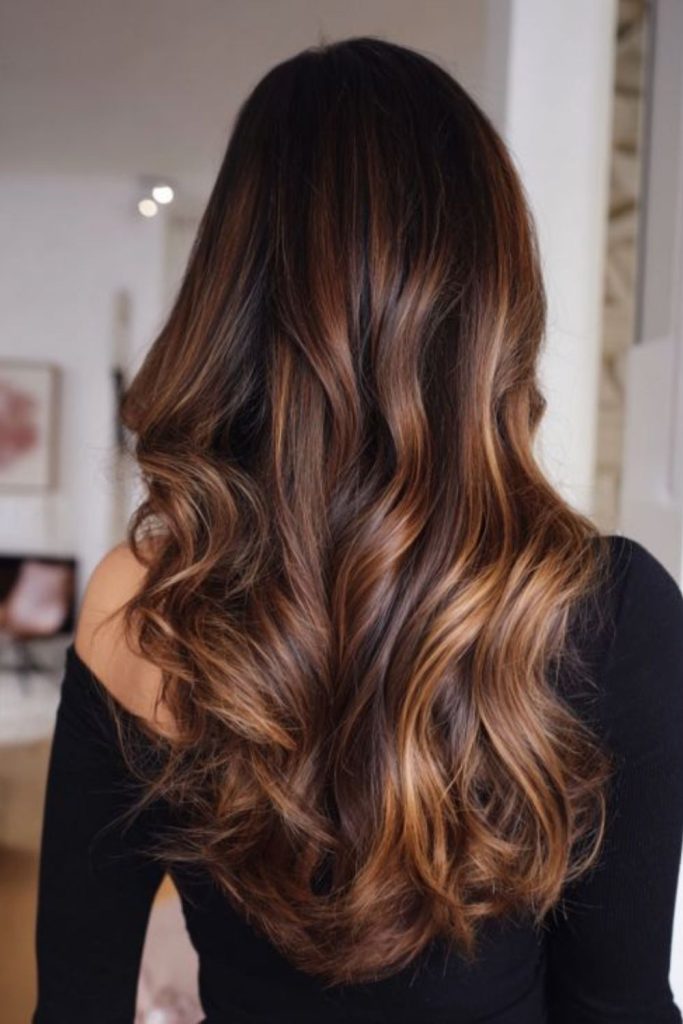Amber toned brown hair with glowing streaks.