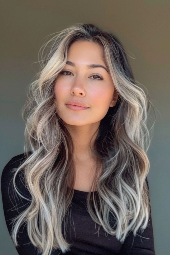 Feathered ash blonde highlights dark hair.