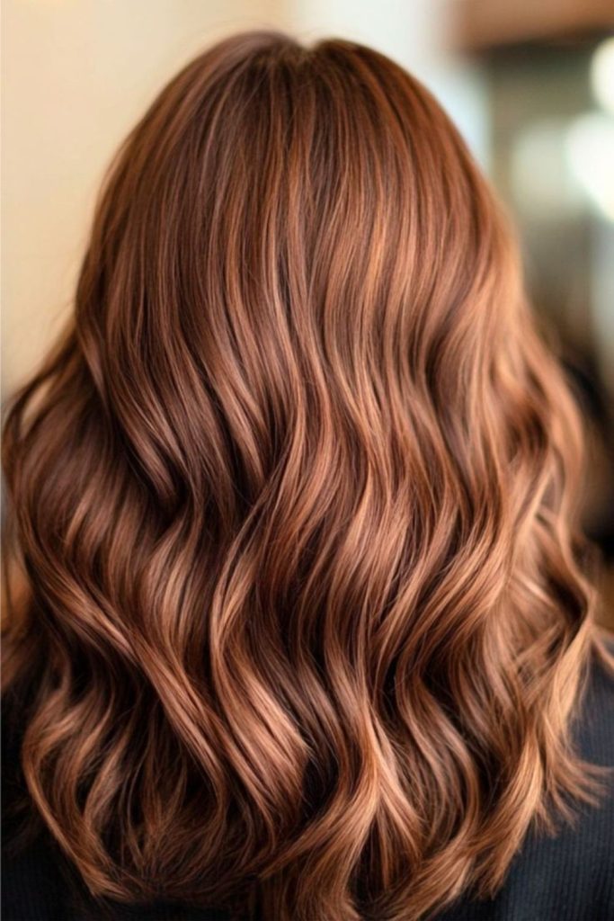 Cinnamon toned brown hair with smoky highlights.