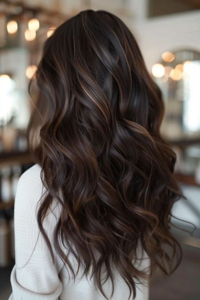Bronze cascade highlights on cocoa hair.