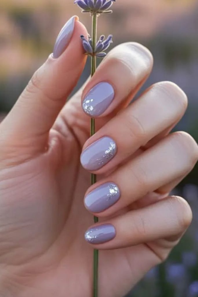 Shimmering lilac nails with stardust sparkle.