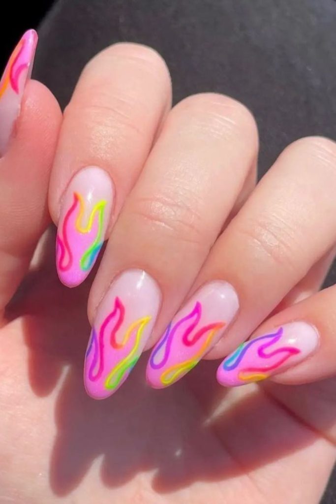 Pastel flames on soft nude nails.