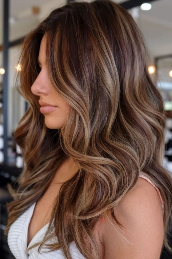 Dark brown hair with honey shadow highlights.