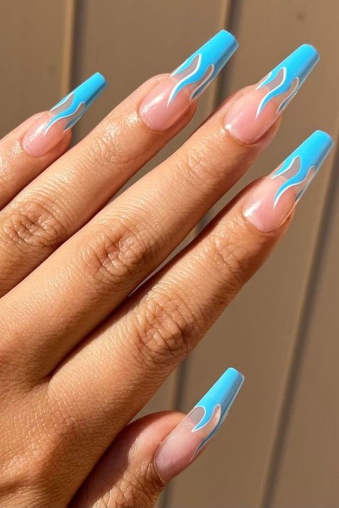 Electric blue flames on clear nails.