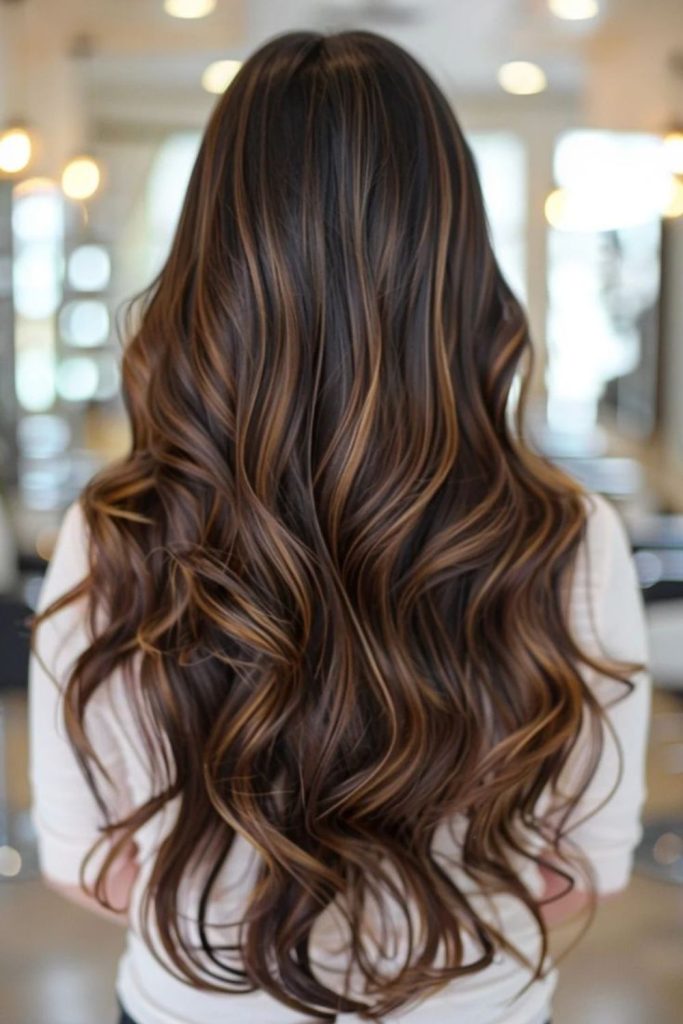 Gold highlights shimmering in espresso brown hair.