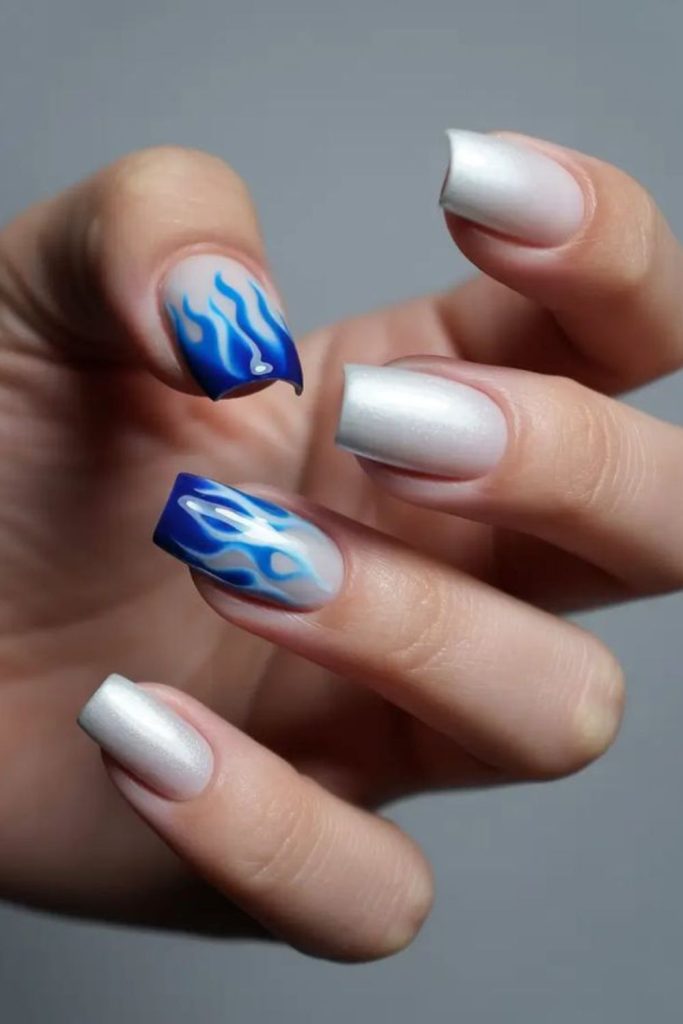 Icy blue flames on white nails.