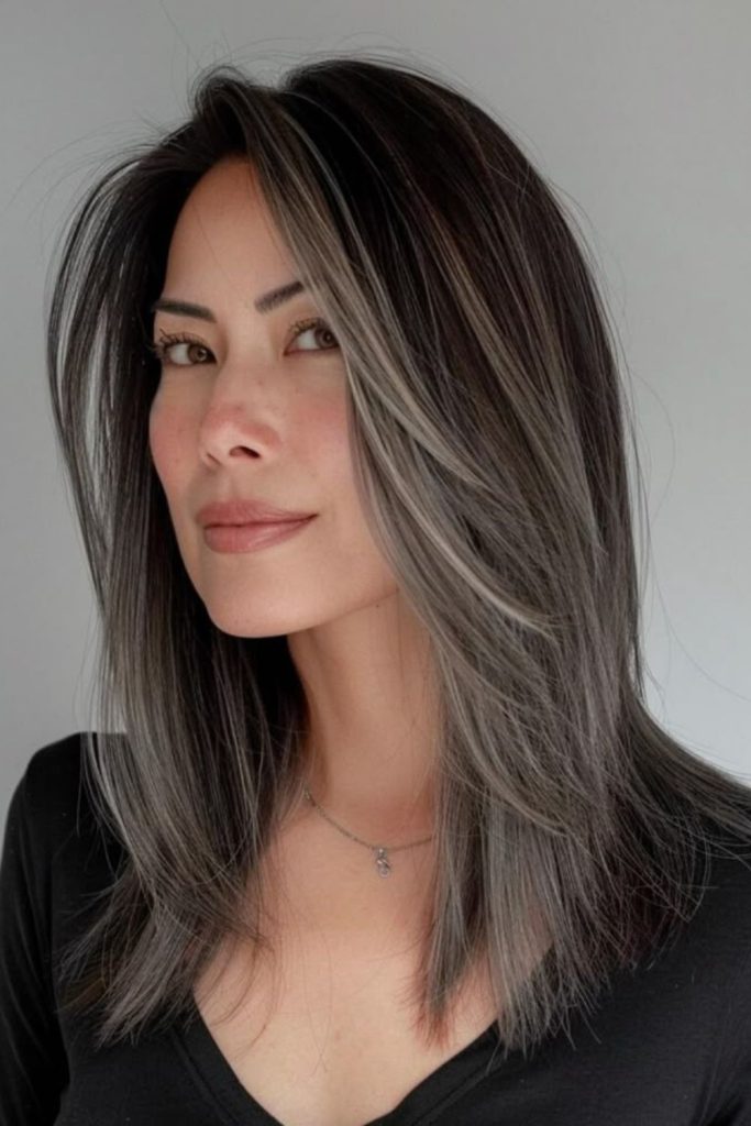 Ghostlike ash highlights dark hair.