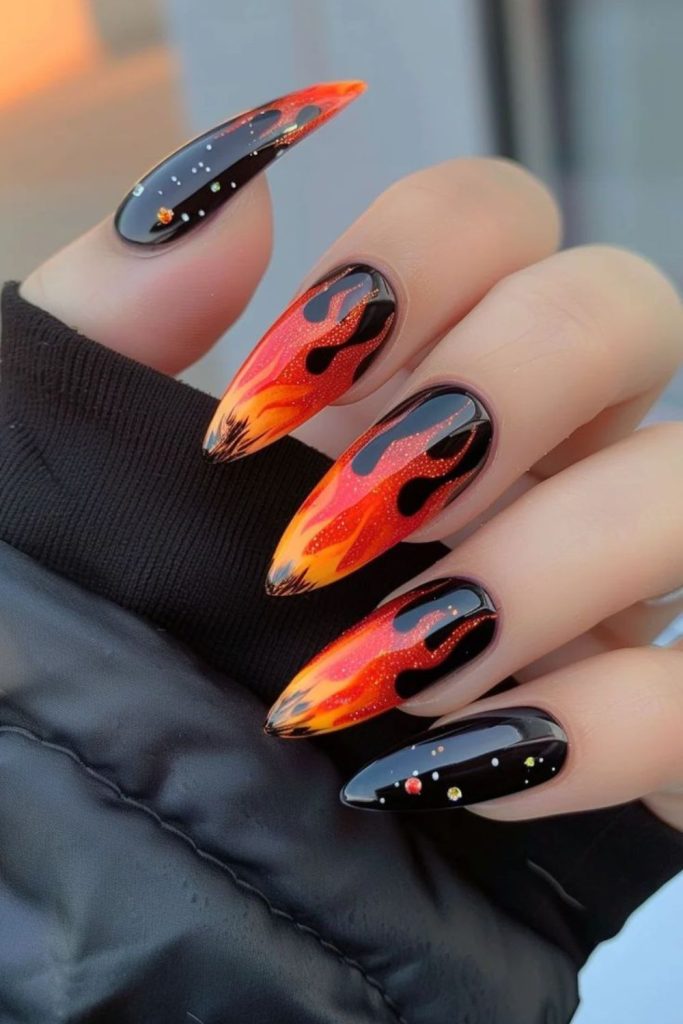 Glitter fade flames on oval nails.