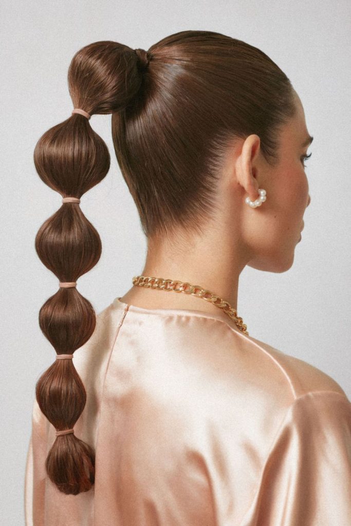 Bubble ponytail with glossy trendy finish.