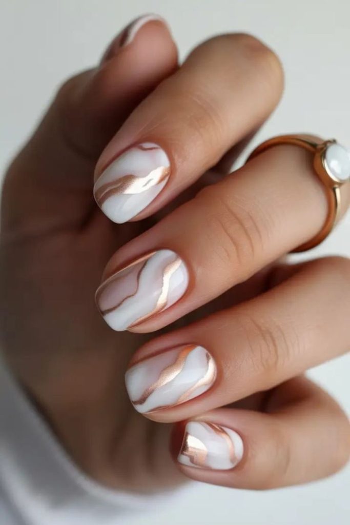 Gold nails streaked with ember accents.