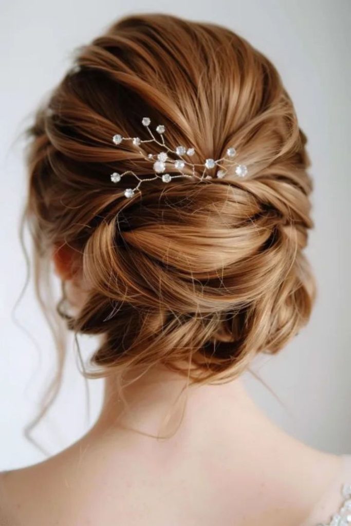 Soft bun with glowing golden strands.