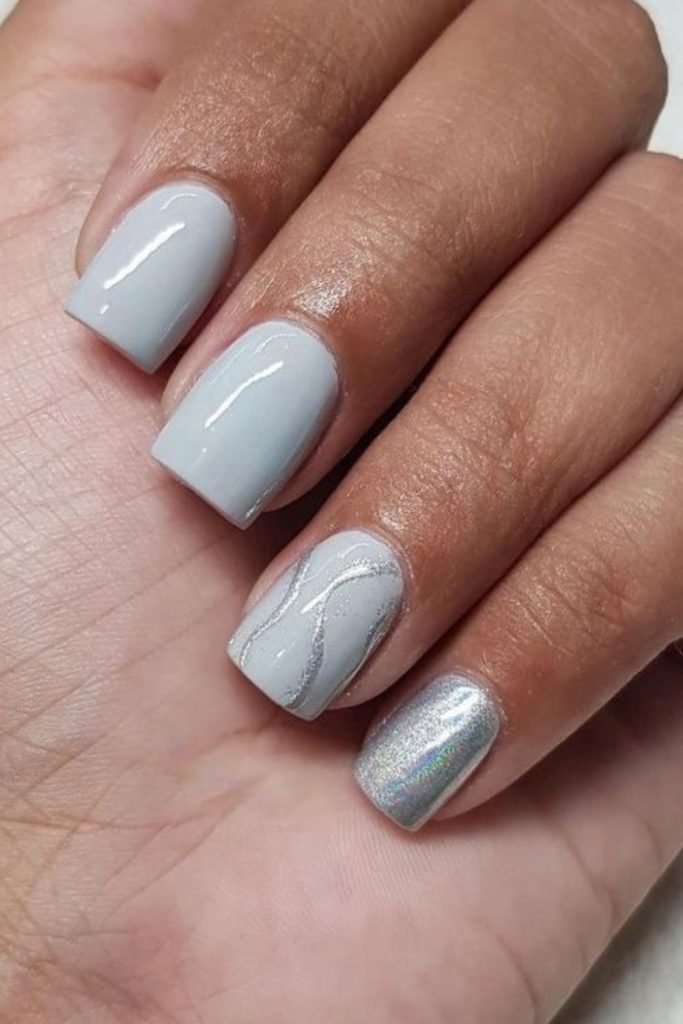 Gray nails with twisted silver swirls.