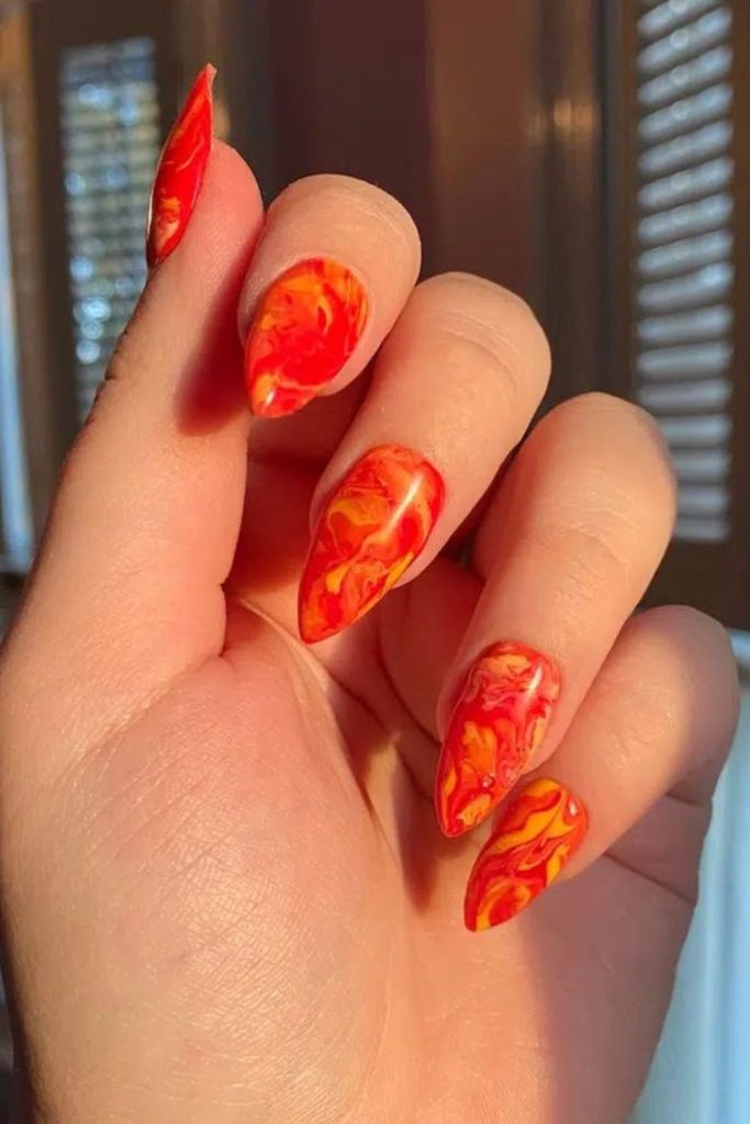 Molten orange nails with fiery accents