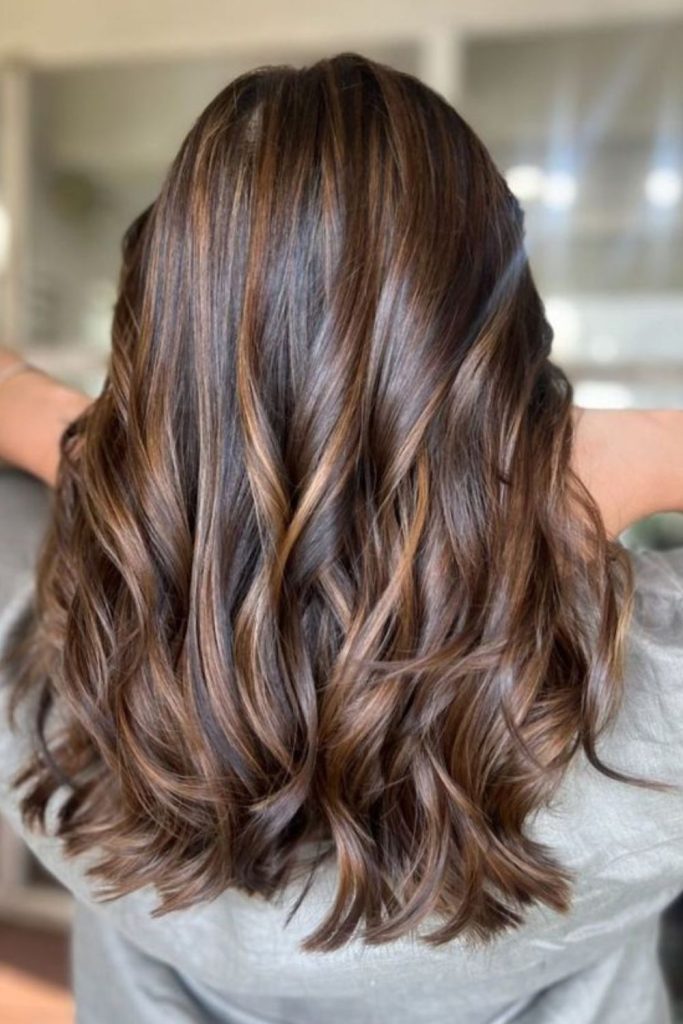 Maple toned highlights on smooth brown hair.