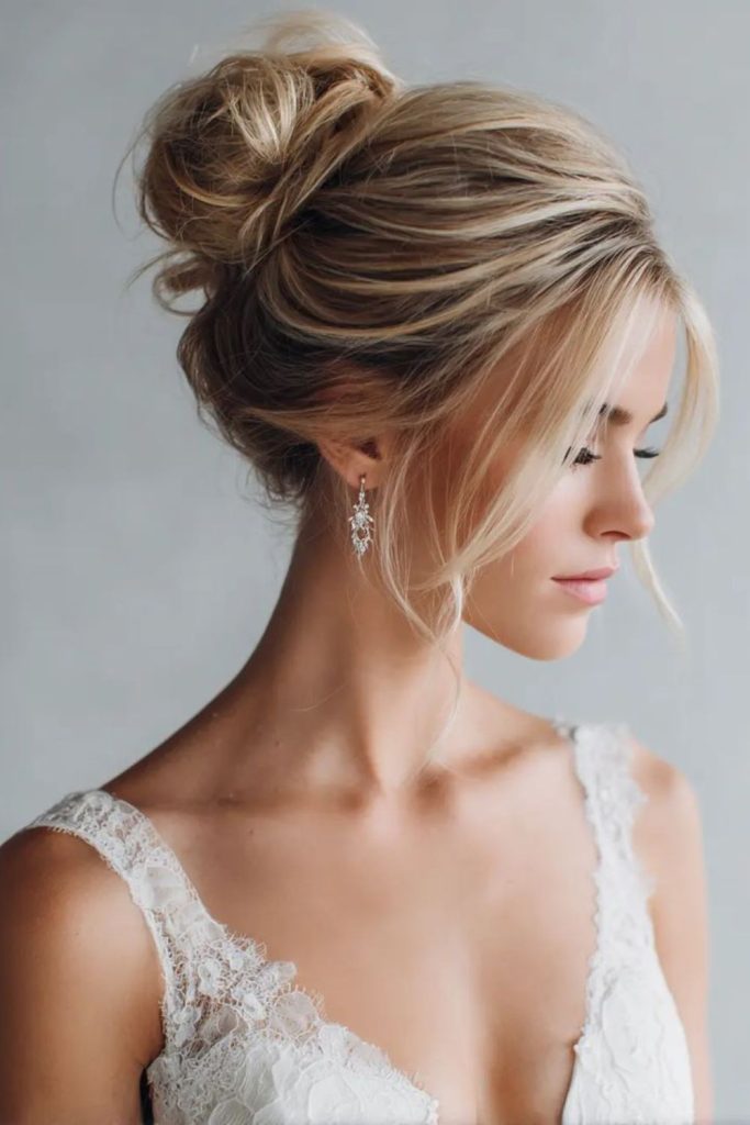 Textured messy bun with loose tendrils