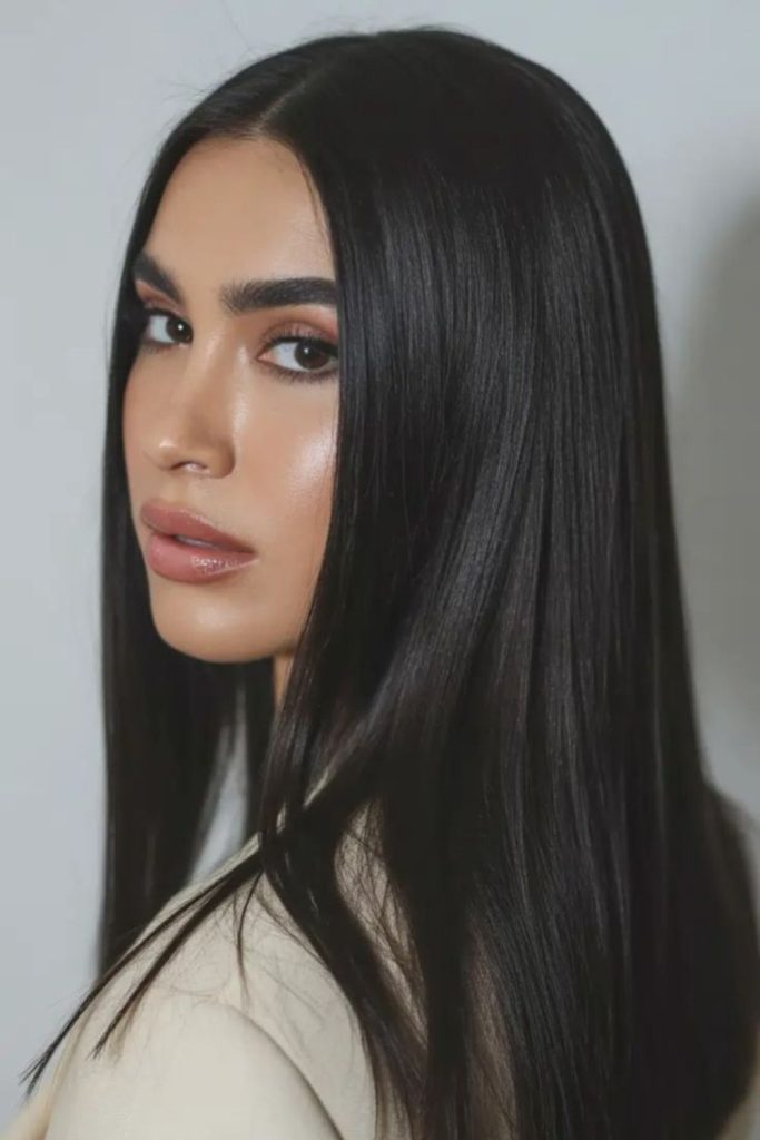 Sleek black hair flowing past shoulders